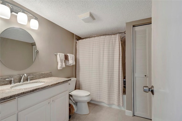 bathroom with visible vents, toilet, tile patterned flooring, a textured ceiling, and vanity