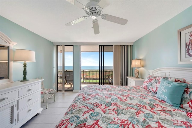 bedroom featuring expansive windows, ceiling fan, light tile patterned floors, and access to exterior