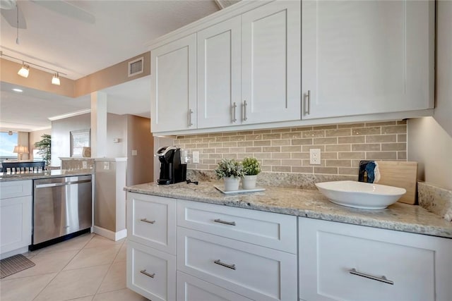 kitchen featuring light tile patterned floors, visible vents, white cabinets, dishwasher, and backsplash