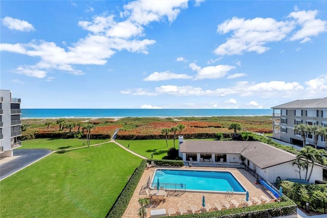 community pool with a water view and a patio