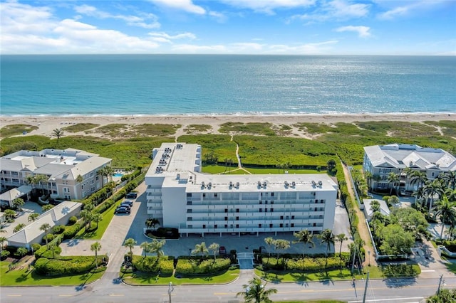 aerial view with a water view and a view of the beach