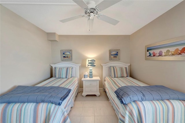 bedroom featuring light tile patterned floors, a ceiling fan, and baseboards