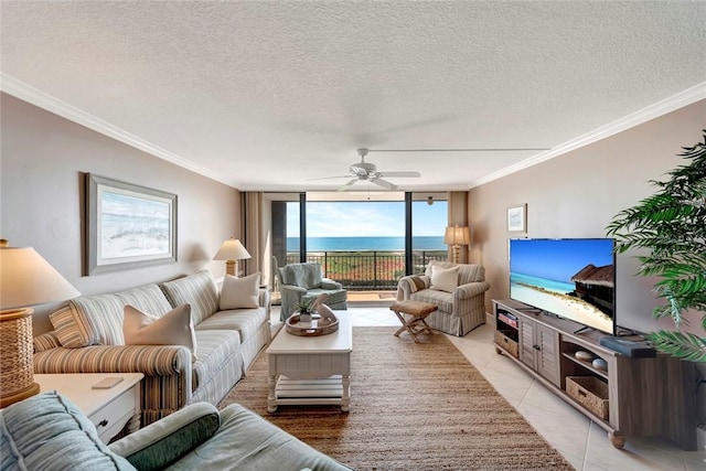 living room with expansive windows, light tile patterned floors, a textured ceiling, and crown molding