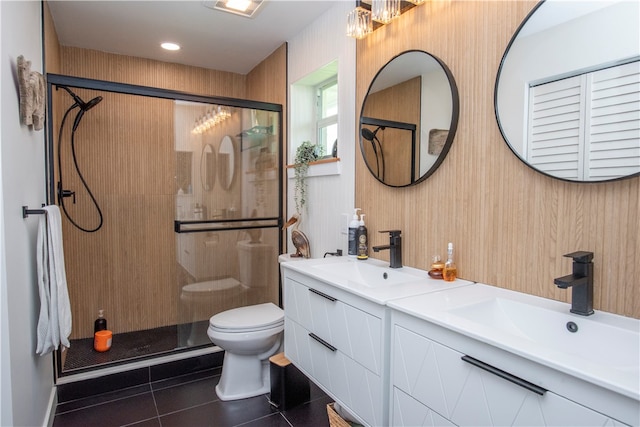 bathroom with toilet, an enclosed shower, vanity, and tile patterned floors