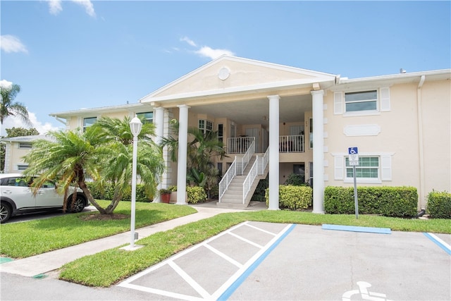 view of parking / parking lot with a lawn