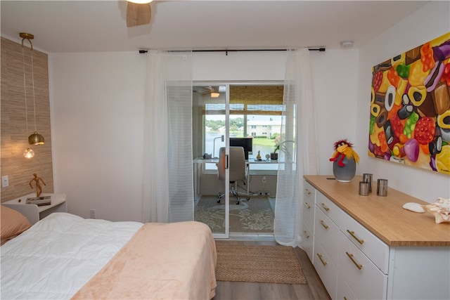 bedroom with light hardwood / wood-style floors, ceiling fan, and a closet