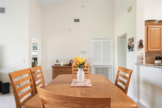 255 Grand Royale Cir Unit 204, Vero Beach, FL 32962 - dining area featuring a towering ceiling and light tile patterned flooring