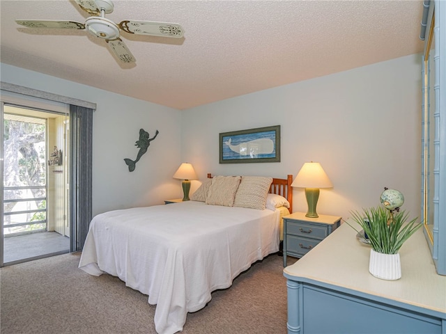 carpeted bedroom with a textured ceiling, ceiling fan, and access to exterior