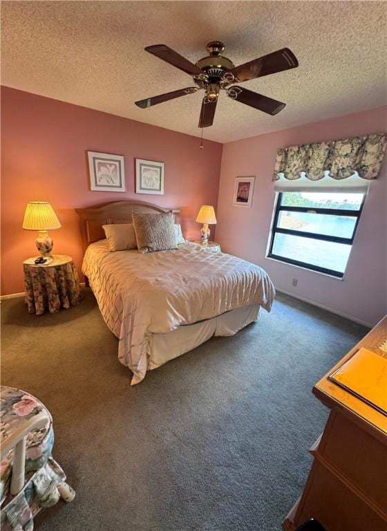 carpeted bedroom featuring a ceiling fan, a textured ceiling, and baseboards