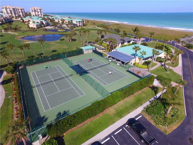 drone / aerial view with a beach view and a water view