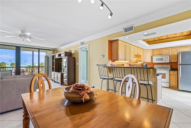 dining room featuring ceiling fan, light tile patterned floors, and ornamental molding