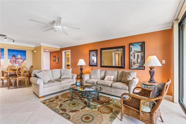 tiled living room featuring ceiling fan, rail lighting, and ornamental molding