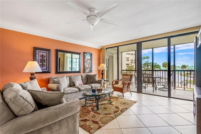 tiled living room featuring ceiling fan, floor to ceiling windows, and crown molding