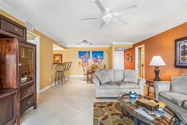 living room with ceiling fan, ornamental molding, and light tile patterned flooring