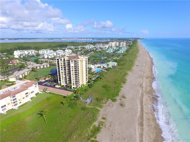 birds eye view of property with a beach view and a water view