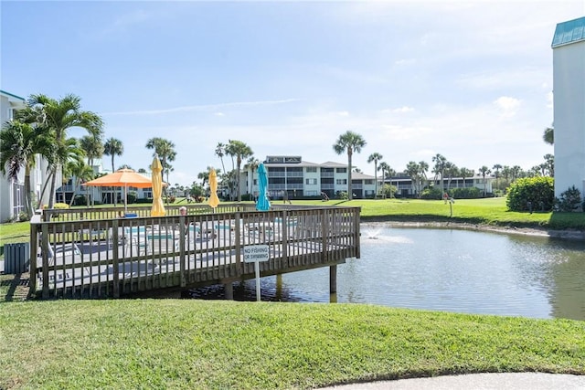 dock area featuring a water view and a lawn