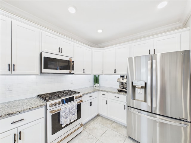 6104 Spicewood Ln, Vero Beach, FL 32966 - kitchen featuring white appliances, ornamental molding, white cabinets, light tile patterned flooring, and light stone countertops