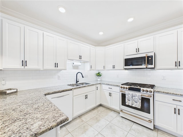 6104 Spicewood Ln, Vero Beach, FL 32966 - kitchen with gas stove, white cabinetry, backsplash, crown molding, and recessed lighting