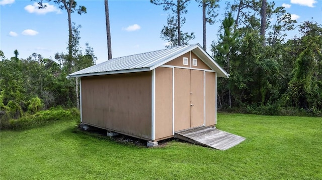 view of outdoor structure featuring a lawn