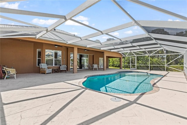 view of pool featuring ceiling fan, a lanai, and a patio area