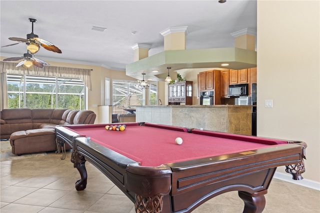 recreation room with ornamental molding, light tile patterned floors, and ceiling fan