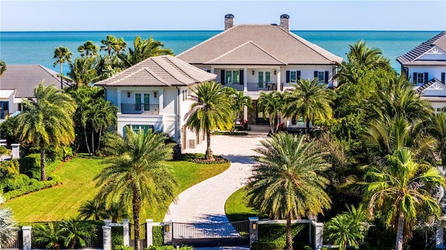 view of front of home with a balcony and a water view