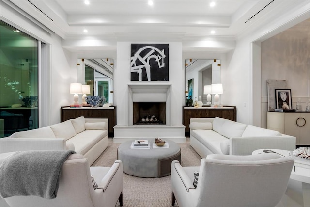 living room with a tray ceiling and ornamental molding