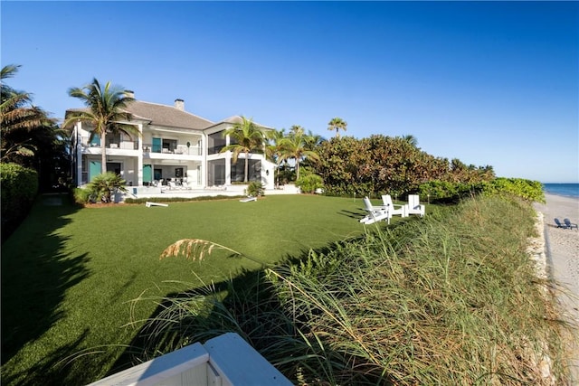 view of yard with a balcony and a water view