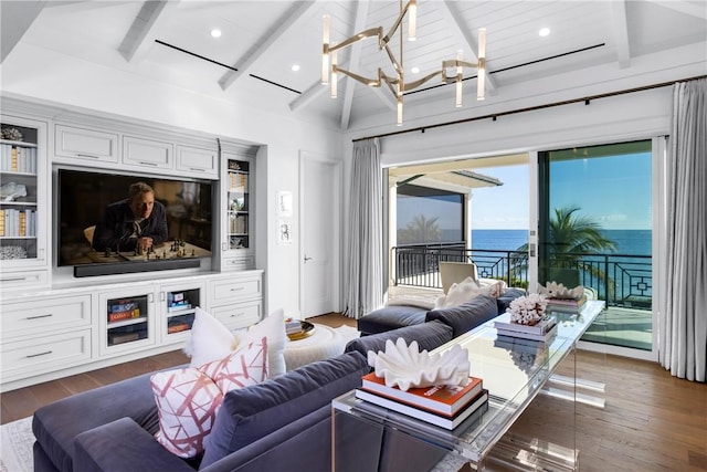 living room with dark hardwood / wood-style flooring, a water view, beamed ceiling, and a notable chandelier