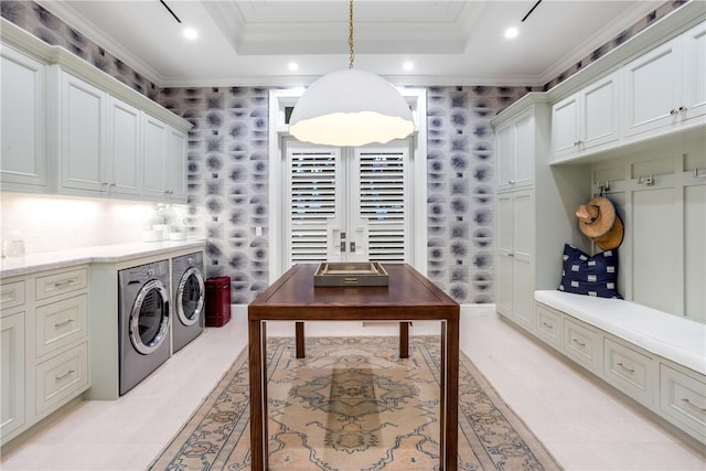 laundry area featuring cabinets, independent washer and dryer, light tile patterned floors, and ornamental molding