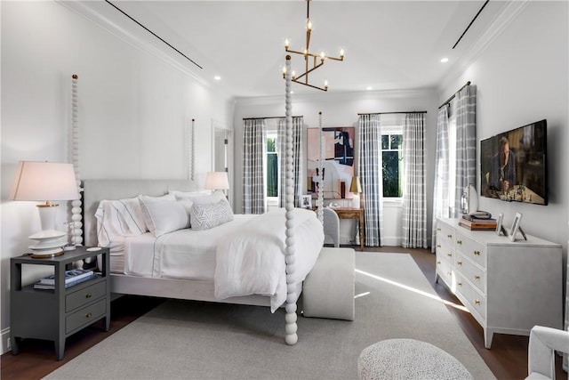 bedroom with a notable chandelier, dark hardwood / wood-style floors, and ornamental molding