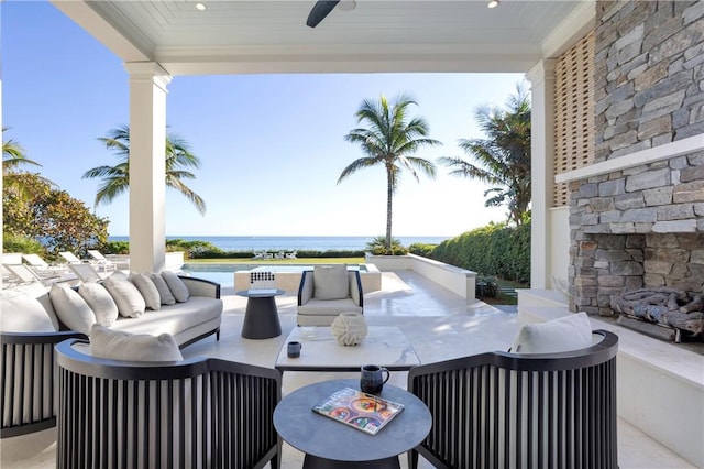 view of patio / terrace with outdoor lounge area, a water view, and ceiling fan