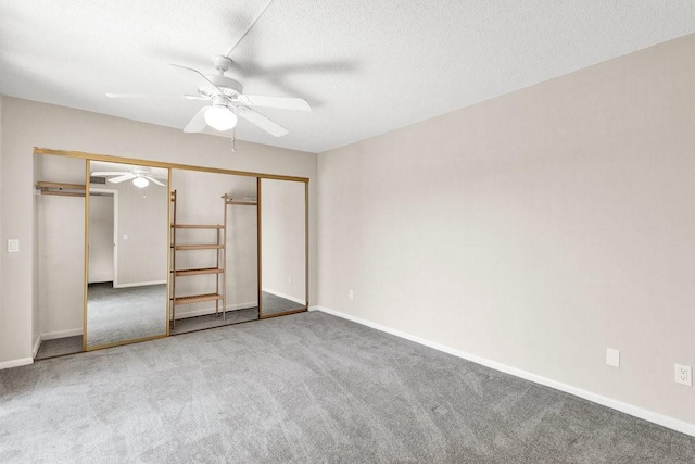 1166 6th Ave Unit 19C, Vero Beach, FL 32960 - unfurnished bedroom with carpet floors, baseboards, a ceiling fan, a textured ceiling, and a closet