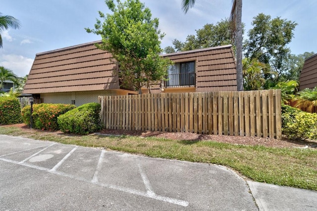 1166 6th Ave Unit 19C, Vero Beach, FL 32960 - view of front of property featuring brick siding and mansard roof