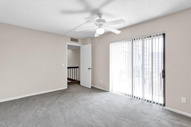 1166 6th Ave Unit 19C, Vero Beach, FL 32960 - empty room featuring carpet floors, a ceiling fan, baseboards, and a textured ceiling