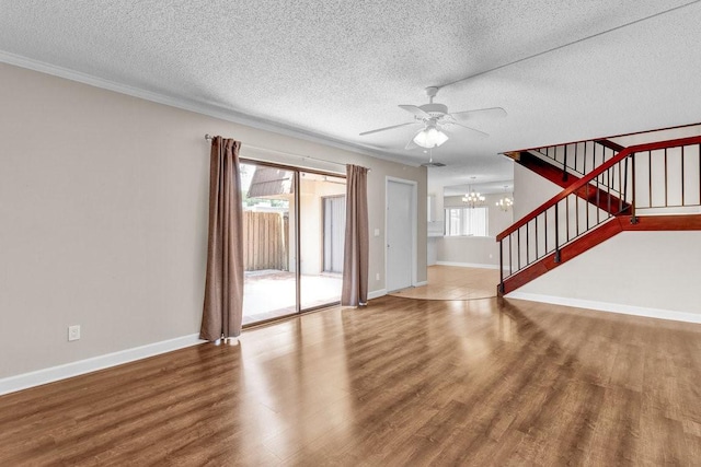 1166 6th Ave Unit 19C, Vero Beach, FL 32960 - unfurnished living room with a chandelier, wood finished floors, a textured ceiling, stairs, and baseboards