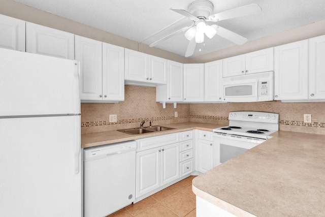 1166 6th Ave Unit 19C, Vero Beach, FL 32960 - kitchen featuring white appliances, a sink, white cabinets, light tile patterned floors, and ceiling fan
