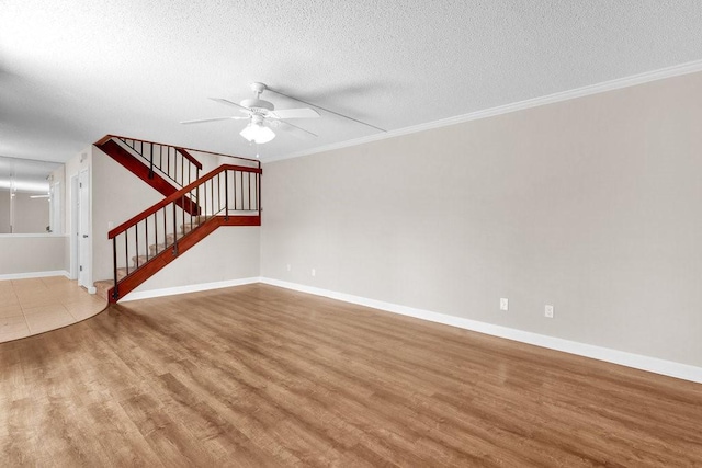 1166 6th Ave Unit 19C, Vero Beach, FL 32960 - unfurnished living room with ceiling fan, wood finished floors, a textured ceiling, baseboards, and stairs