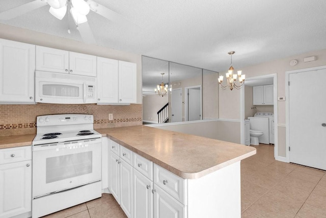 1166 6th Ave Unit 19C, Vero Beach, FL 32960 - kitchen featuring white appliances, a chandelier, a peninsula, washing machine and clothes dryer, and light tile patterned floors