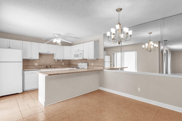 1166 6th Ave Unit 19C, Vero Beach, FL 32960 - kitchen with white appliances, a chandelier, light countertops, a sink, and a textured ceiling