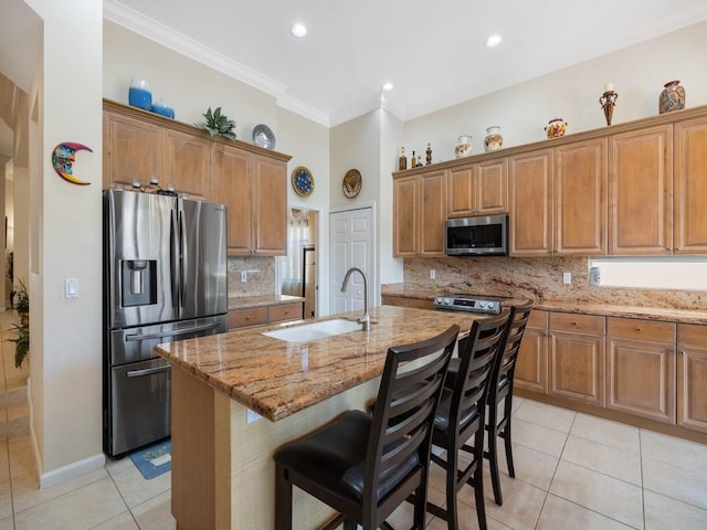 9535 E Maiden Ct, Vero Beach, FL 32963 - kitchen with appliances with stainless steel finishes, light tile patterned floors, light stone counters, brown cabinets, and crown molding