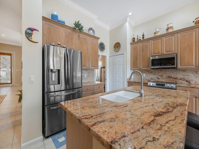 9535 E Maiden Ct, Vero Beach, FL 32963 - kitchen with stainless steel appliances, light tile patterned floors, light stone counters, crown molding, and backsplash