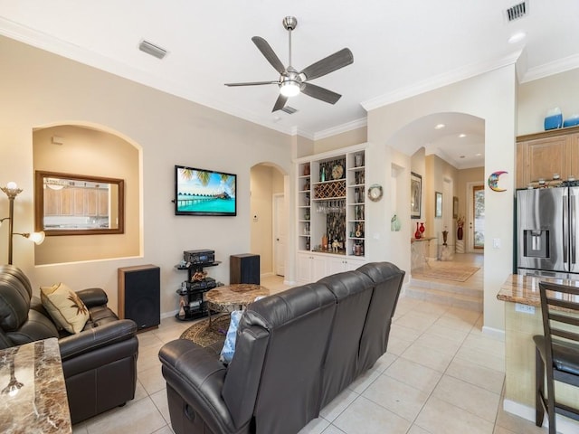 9535 E Maiden Ct, Vero Beach, FL 32963 - living room featuring arched walkways, ornamental molding, ceiling fan, light tile patterned flooring, and built in features