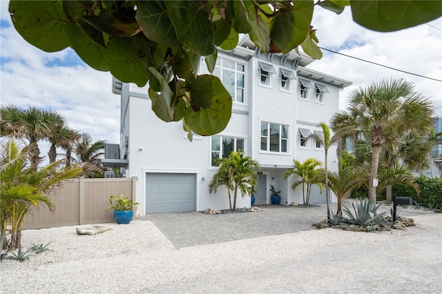 view of front of house with cooling unit and a garage