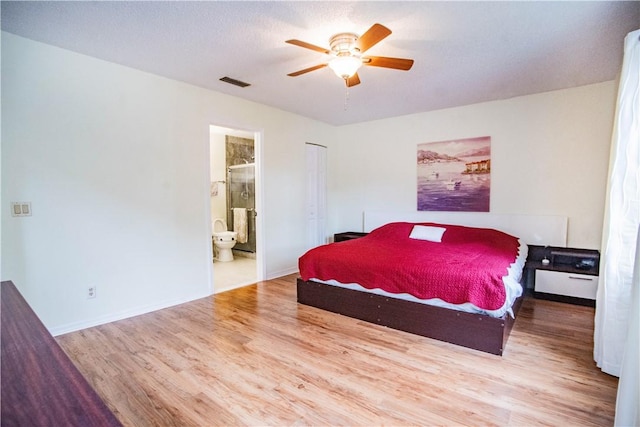 bedroom featuring ensuite bathroom, ceiling fan, a textured ceiling, and hardwood / wood-style flooring