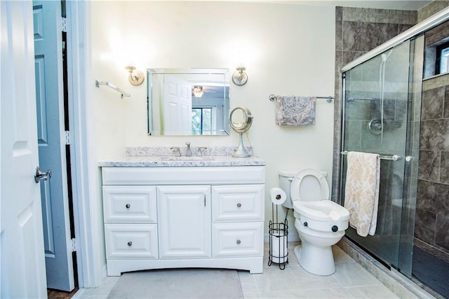 bathroom featuring an enclosed shower, vanity, tile patterned floors, and toilet