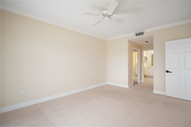 empty room featuring ceiling fan, crown molding, and light carpet