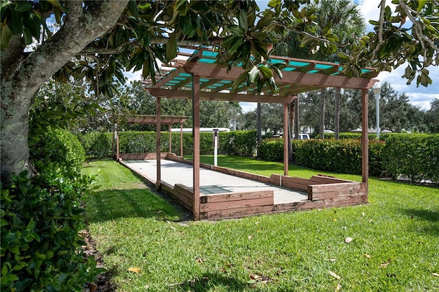 surrounding community featuring a pergola and a yard