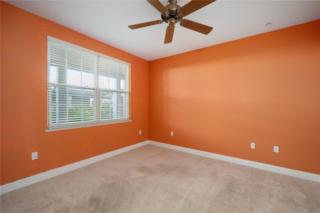 unfurnished room featuring light colored carpet and ceiling fan