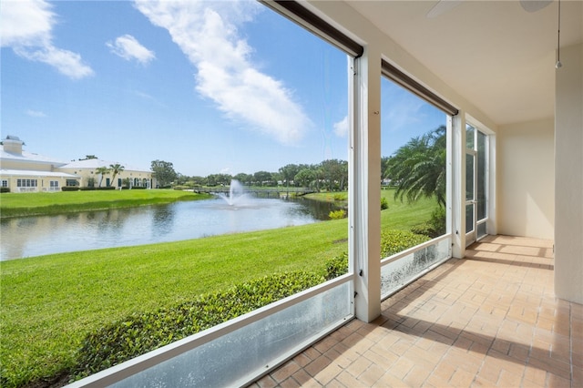 unfurnished sunroom with a water view